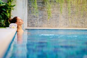 Woman in a pool enjoying her free credit card perks