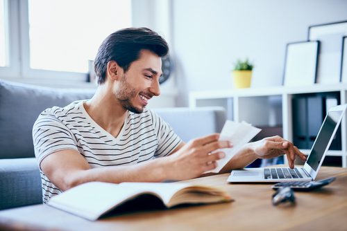 Man reading the fine print on his first credit card