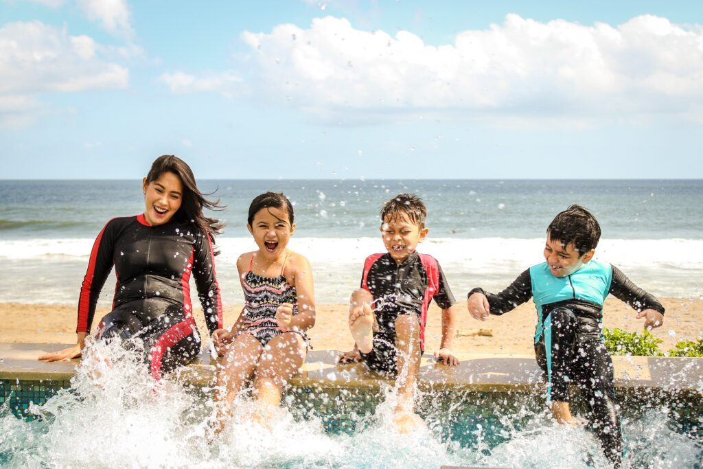 Family on vacation smashing in the water